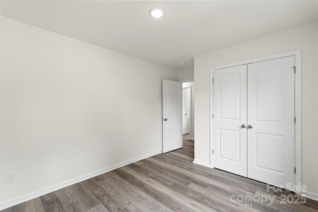 510 3rd St, Salisbury, NC 28144 - unfurnished bedroom with baseboards, wood finished floors, a closet, and recessed lighting