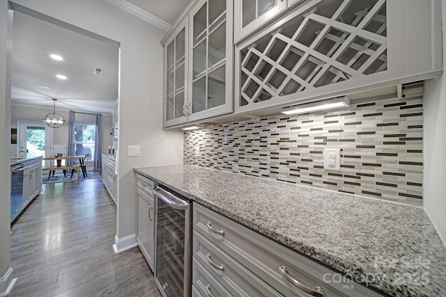 5424 Tilley Manor Dr, Matthews, NC 28105 - kitchen with wine cooler, crown molding, dark wood-style flooring, decorative backsplash, and light stone counters