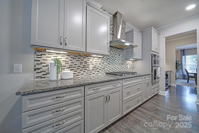 5424 Tilley Manor Dr, Matthews, NC 28105 - kitchen featuring wall chimney exhaust hood, stainless steel appliances, dark wood finished floors, backsplash, and ornamental molding