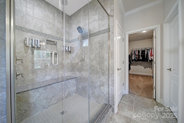 5424 Tilley Manor Dr, Matthews, NC 28105 - full bathroom featuring crown molding, a shower stall, a spacious closet, and tile patterned floors