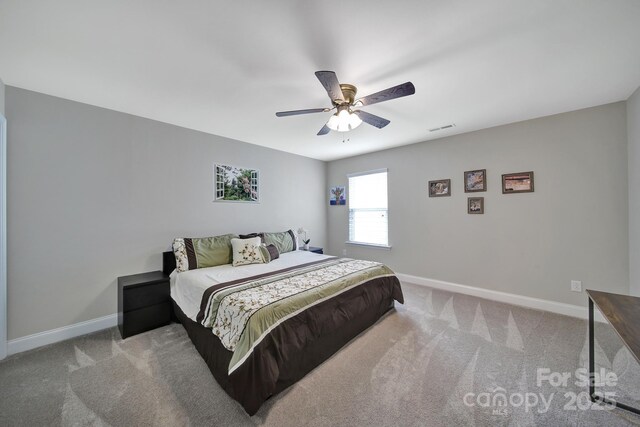 5424 Tilley Manor Dr, Matthews, NC 28105 - carpeted bedroom featuring baseboards and ceiling fan