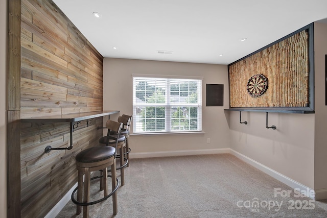 5424 Tilley Manor Dr, Matthews, NC 28105 - living area with wooden walls, carpet flooring, recessed lighting, and a bar