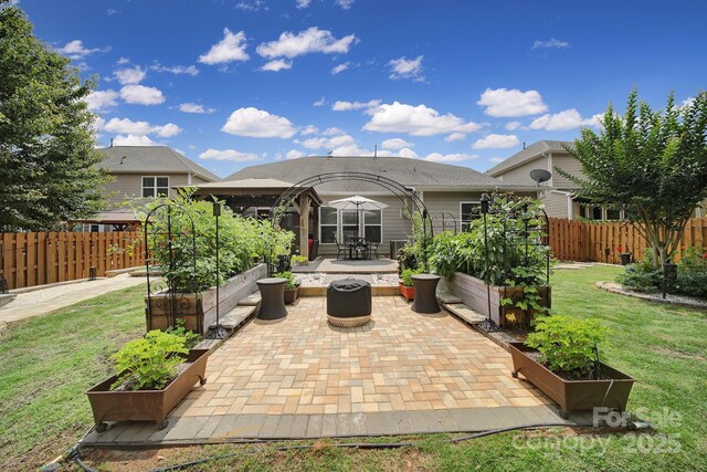 5424 Tilley Manor Dr, Matthews, NC 28105 - view of patio / terrace with a vegetable garden and a fire pit