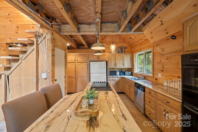 193 Falls View Dr, Lake Toxaway, NC 28747 - kitchen with appliances with stainless steel finishes, wooden walls, light stone counters, and decorative light fixtures