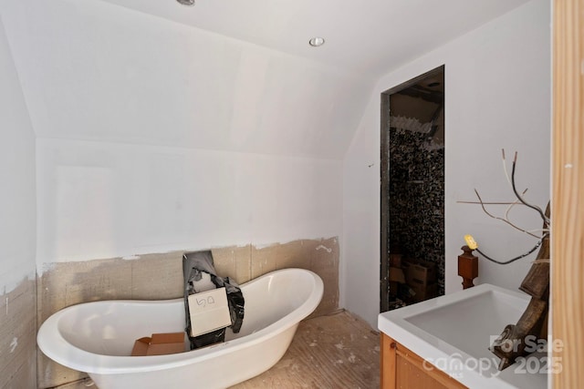 193 Falls View Dr, Lake Toxaway, NC 28747 - bathroom with vanity, a soaking tub, lofted ceiling, a shower, and wood finished floors