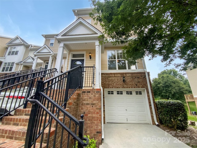 7130 Founders Club Ct, Charlotte, NC 28269 - view of front of property with a garage, driveway, brick siding, and stairs