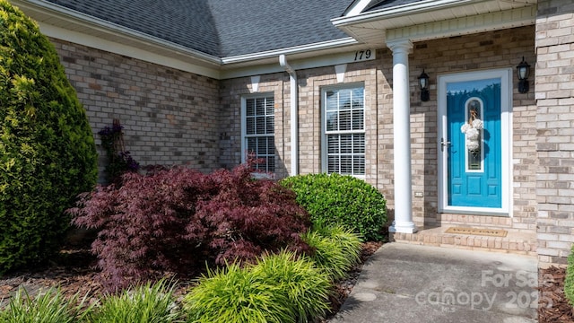 179 Browning Dr, Taylorsville, NC 28681 - view of exterior entry featuring a shingled roof and brick siding
