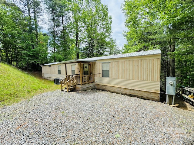 477 Parkway Dr, Jefferson, NC 28694 - manufactured / mobile home featuring central air condition unit, view of wooded area, and metal roof