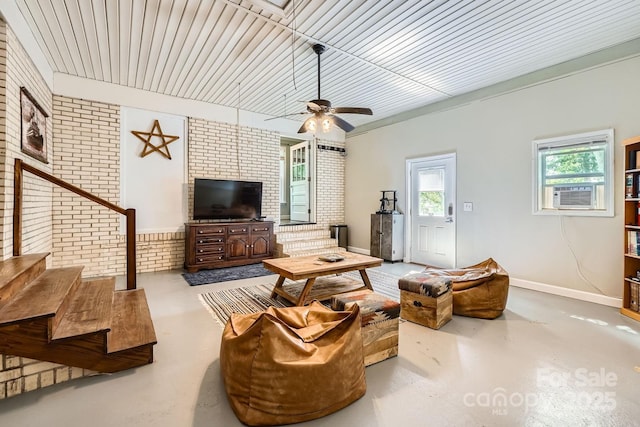 1175 18th Ave NE, Hickory, NC 28601 - living room with concrete flooring, brick wall, baseboards, a ceiling fan, and stairway