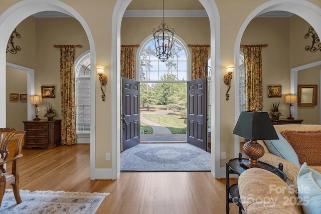 1629 Southpoint Ln, New London, NC 28127 - entryway with a chandelier, wood finished floors, arched walkways, and baseboards