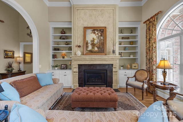 1629 Southpoint Ln, New London, NC 28127 - living room with built in features, light wood-style floors, arched walkways, crown molding, and a high end fireplace