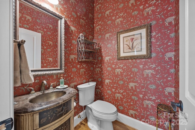 1629 Southpoint Ln, New London, NC 28127 - half bathroom with vanity, wood finished floors, toilet, and baseboards
