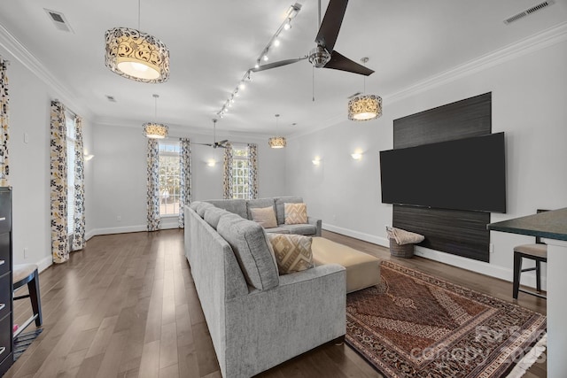 1629 Southpoint Ln, New London, NC 28127 - living area with wood finished floors, baseboards, rail lighting, and crown molding
