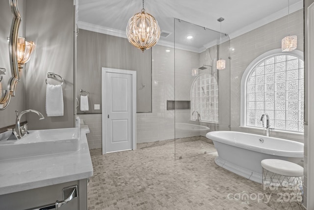 1629 Southpoint Ln, New London, NC 28127 - bathroom with double vanity, a chandelier, crown molding, tile walls, and a soaking tub