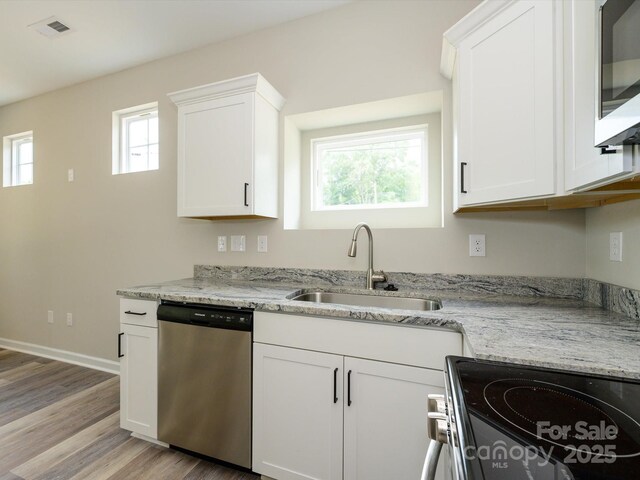 102 Mobley St, Clover, SC 29710 - kitchen with stainless steel appliances, white cabinets, light wood-style flooring, and light stone countertops