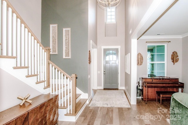 13708 Huntson Park Ln, Huntersville, NC 28078 - foyer entrance featuring wood finished floors, stairs, a towering ceiling, and crown molding