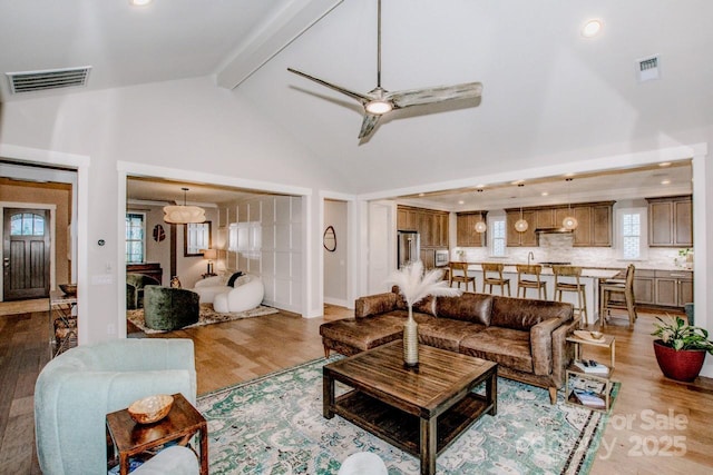 13708 Huntson Park Ln, Huntersville, NC 28078 - living room with wood finished floors, high vaulted ceiling, beamed ceiling, ceiling fan, and healthy amount of natural light