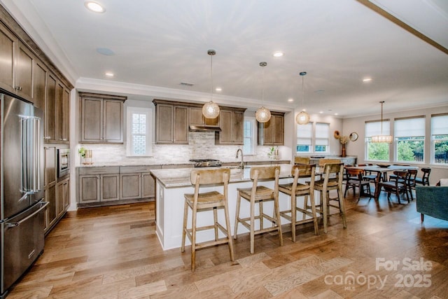 13708 Huntson Park Ln, Huntersville, NC 28078 - kitchen with high quality fridge, ornamental molding, light stone counters, tasteful backsplash, and an island with sink