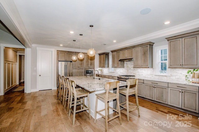 13708 Huntson Park Ln, Huntersville, NC 28078 - kitchen featuring a kitchen breakfast bar, decorative backsplash, light stone counters, a kitchen island with sink, and stainless steel appliances