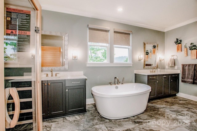 13708 Huntson Park Ln, Huntersville, NC 28078 - bathroom with marble look tile flooring, a freestanding bath, two vanities, crown molding, and recessed lighting