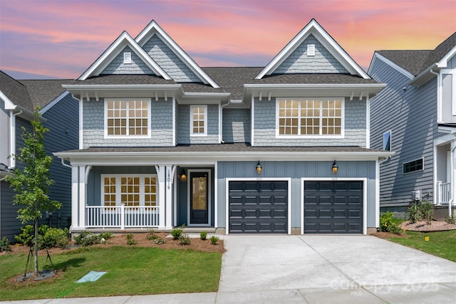 18019 Wilbanks Dr, Charlotte, NC 28278 - view of front of property featuring board and batten siding, driveway, covered porch, an attached garage, and a yard