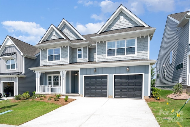 18019 Wilbanks Dr, Charlotte, NC 28278 - view of front facade featuring board and batten siding, a porch, driveway, and a front lawn