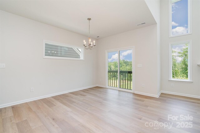 18019 Wilbanks Dr, Charlotte, NC 28278 - unfurnished room featuring a chandelier, light wood finished floors, healthy amount of natural light, and baseboards