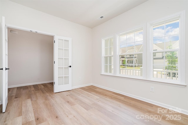 18019 Wilbanks Dr, Charlotte, NC 28278 - unfurnished room with plenty of natural light, french doors, light wood-style floors, and baseboards