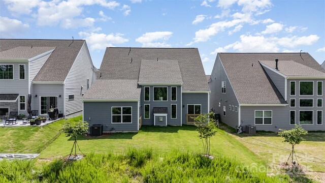 18019 Wilbanks Dr, Charlotte, NC 28278 - back of house featuring cooling unit, a patio, a yard, and a shingled roof