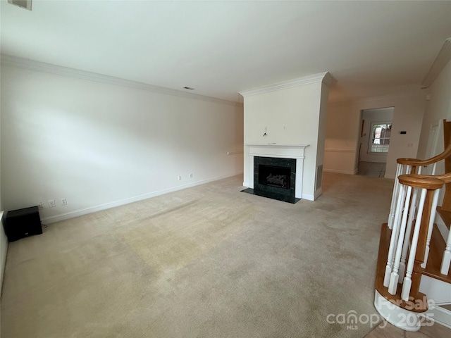 9177 Bonnie Briar Cir, Charlotte, NC 28277 - unfurnished living room with crown molding, light colored carpet, a high end fireplace, baseboards, and stairway