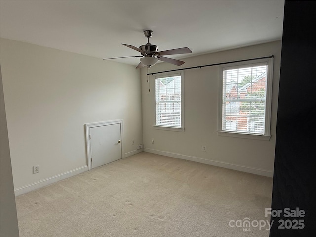 9177 Bonnie Briar Cir, Charlotte, NC 28277 - empty room featuring plenty of natural light, a ceiling fan, light colored carpet, and baseboards