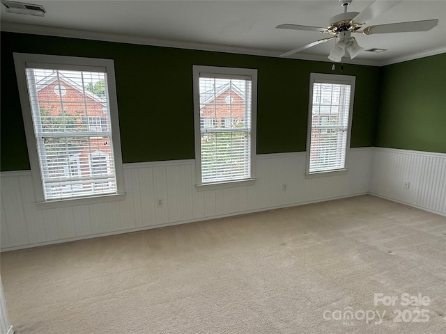 9177 Bonnie Briar Cir, Charlotte, NC 28277 - carpeted empty room with wainscoting, plenty of natural light, ornamental molding, and ceiling fan