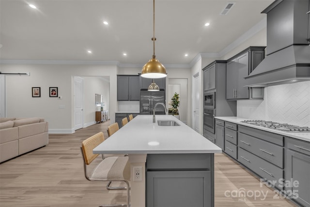 513 Meadow Ridge Dr, Belmont, NC 28012 - kitchen with wall chimney exhaust hood, a sink, stainless steel appliances, ornamental molding, and gray cabinetry