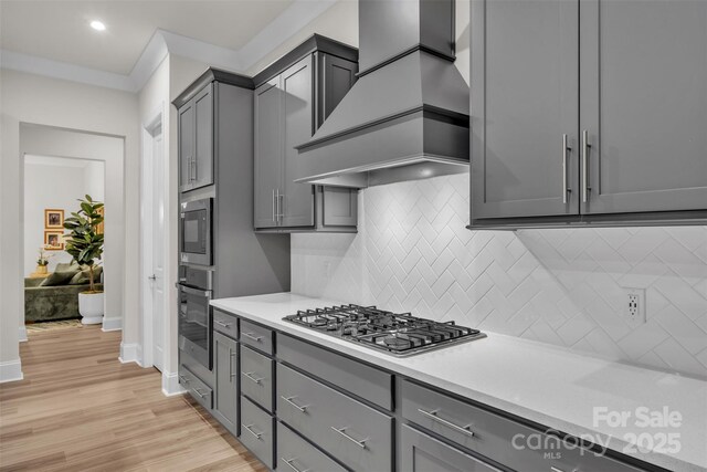 513 Meadow Ridge Dr, Belmont, NC 28012 - kitchen with stainless steel appliances, custom exhaust hood, gray cabinetry, light countertops, and recessed lighting