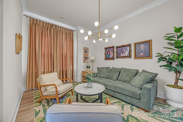 513 Meadow Ridge Dr, Belmont, NC 28012 - living room featuring a chandelier, baseboards, wood finished floors, and ornamental molding
