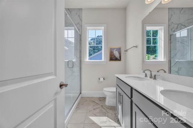 513 Meadow Ridge Dr, Belmont, NC 28012 - bathroom with healthy amount of natural light, marble look tile flooring, double vanity, and toilet