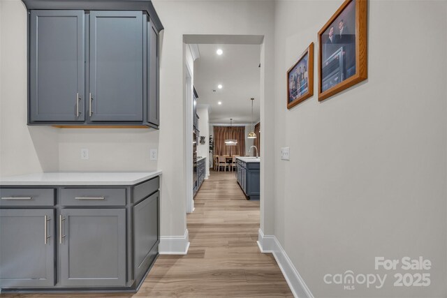 513 Meadow Ridge Dr, Belmont, NC 28012 - hallway featuring light wood-style flooring, baseboards, a sink, and recessed lighting