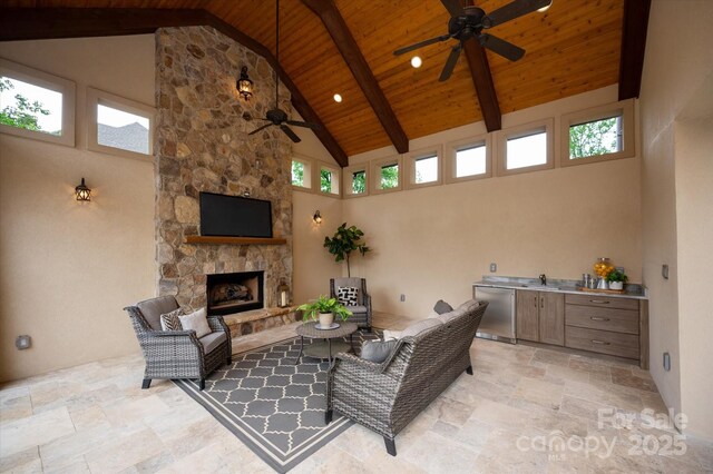 1501 Alydar Ct, Waxhaw, NC 28173 - living room featuring a ceiling fan, high vaulted ceiling, wooden ceiling with exposed beams, stone tile flooring, and an outdoor stone fireplace