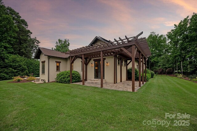 1501 Alydar Ct, Waxhaw, NC 28173 - rear view of house featuring a pergola, a patio area, a yard, stucco siding, and a tile roof