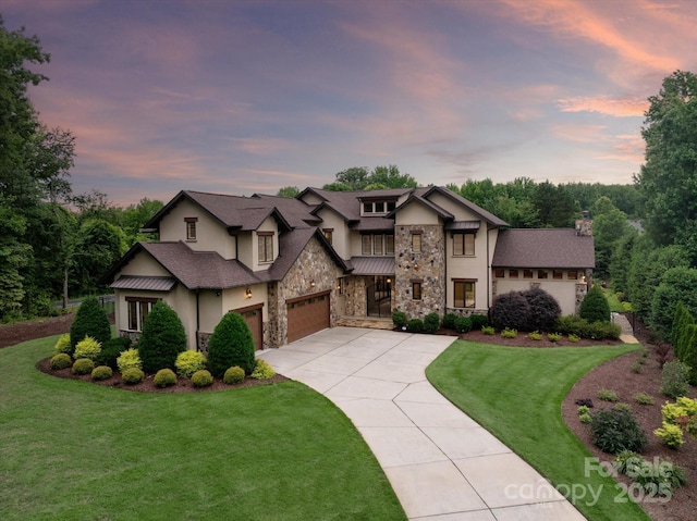 1501 Alydar Ct, Waxhaw, NC 28173 - view of front of house featuring driveway, a front yard, stone siding, an attached garage, and stucco siding