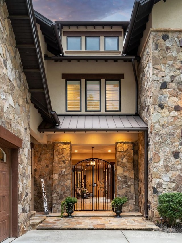1501 Alydar Ct, Waxhaw, NC 28173 - entrance to property with stone siding, a standing seam roof, stucco siding, and metal roof