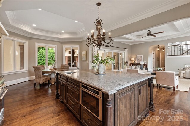 1501 Alydar Ct, Waxhaw, NC 28173 - kitchen with a sink, dark wood-style flooring, a chandelier, light stone counters, and recessed lighting