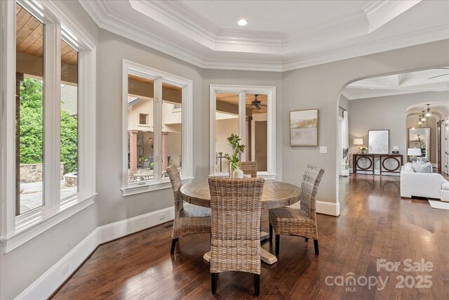 1501 Alydar Ct, Waxhaw, NC 28173 - dining area with arched walkways, crown molding, wood finished floors, baseboards, and a tray ceiling