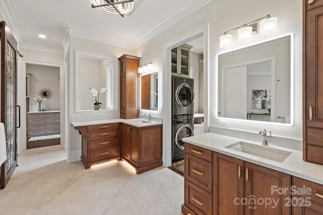 1501 Alydar Ct, Waxhaw, NC 28173 - full bathroom featuring estacked washer and dryer, two vanities, and ornamental molding