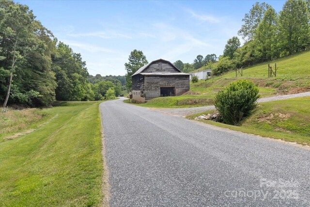 461 Tweed Rd, Madison, NC 28753 - view of asphalt road with a barn