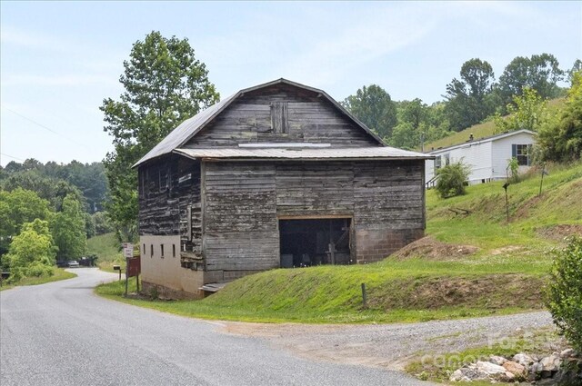 461 Tweed Rd, Madison, NC 28753 - view of side of property with a detached garage, a barn, and an outbuilding