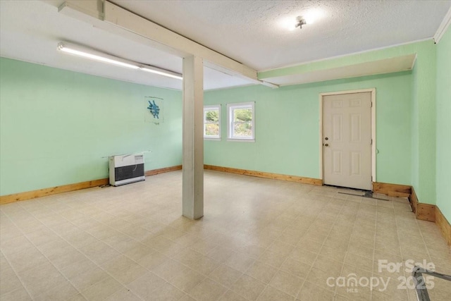 461 Tweed Rd, Madison, NC 28753 - basement featuring heating unit, a textured ceiling, and tile patterned floors