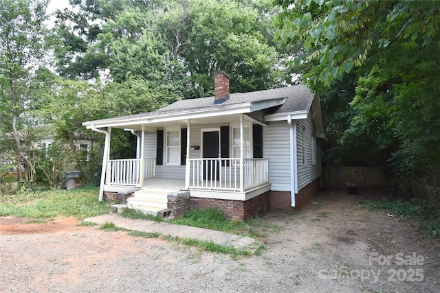 2017 Ashley Rd, Charlotte, NC 28208 - bungalow-style house with a porch, a chimney, and roof with shingles