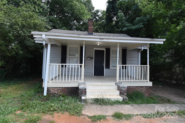2017 Ashley Rd, Charlotte, NC 28208 - bungalow-style house with a chimney and a porch