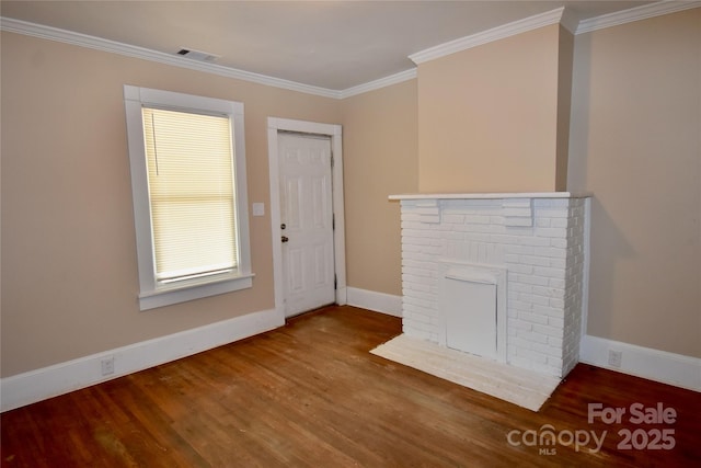 2017 Ashley Rd, Charlotte, NC 28208 - unfurnished living room featuring wood finished floors, crown molding, and a brick fireplace